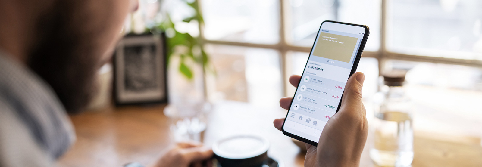 Person looking at their bank app on their phone.